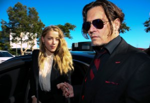 Actor Johnny Depp and his wife Amber Heard arrive on April 18, 2016, at a court in Australia for a hearing Heard's alleged illegal importation of their two Yorkshire terrier dogs. (Credit: PATRICK HAMILTON/AFP/Getty Images)
