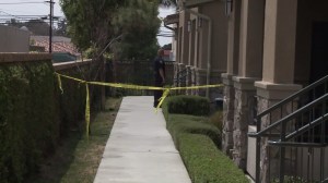 A police official investigates after a toddler fell from a third-story window in Orange on May 10, 2016. (Credit: KTLA)