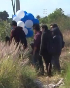 Dozens of mourners brought blue and white balloons to a memorial for Carlos Jovel, 16, and Gustavo Ramirez, 15, on May 2, 2016. (Credit: KTLA)
