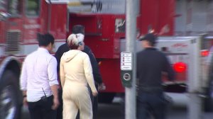 Anita McMillan-Murphy is escorted over to talk to the man on the tower after recognizing him from church on May 11, 2016. (Credit: KTLA)