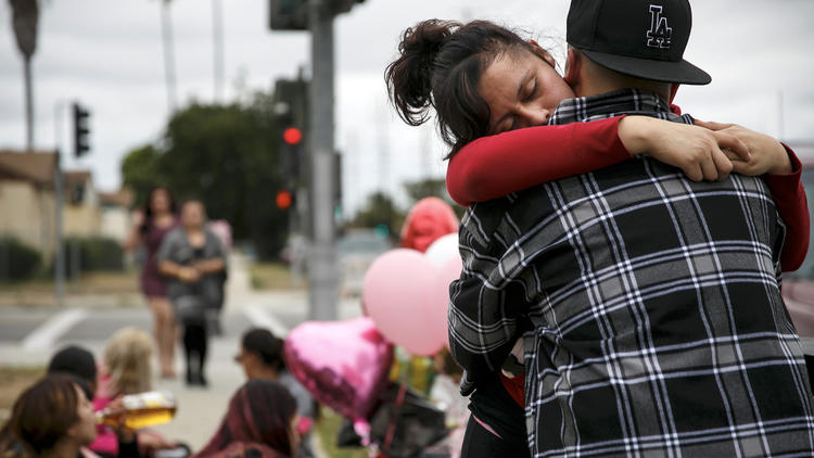 Miriam Ambriz gets an embrace as she mourns the loss of her sister, Cynthia Ambriz, 19, who was shot and killed while walking in Carson on June 11, 2016. (Credit: Marcus Yam/Los Angeles Times)