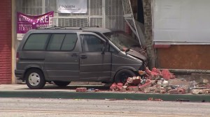 One person was killed after a driver was unable to avoid hitting a bicyclist and crashed into a building in Compton on June 6, 2016. (Credit: KTLA)