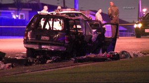 Sheriff's officials investigate a fire at an SUV that left a woman and child dead in Willowbrook on June 16, 2016. (Credit: OnScene.TV)