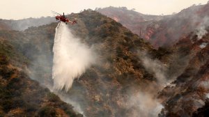 Helicopters make water drops on Spinks Canyon above Duarte Tuesday morning as two brush fires burn dangerously close to one another in Duarte and Azusa. The two fires have charred 5,400 acres. (Credit: Al Seib/Los Angeles Times)