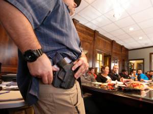 Damon Thueson shows a holster at a gun concealed carry permit class put on by 'USA Firearms Training' on December 19, 2015 in Provo, Utah. (Credit: George Frey/Getty Images)