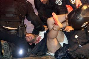 Israeli policemen arrest a suspect shortly after a shooting attack in Tel Aviv on June 8, 2016. (Credit: STRINGER/AFP/Getty Images)