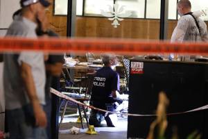 Israeli forensic police inspect a restaurant following a shooting attack at a shopping complex in the Mediterranean coastal city of Tel Aviv on June 8, 2016. (Credit: JACK GUEZ/AFP/Getty Images)