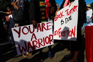 Stanford students carry signs during the 'Wacky Walk' to show their solidarity for a Stanford sexual assault victim during graduation ceremonies at Stanford University in Palo Alto, on June 12, 2016. (Credit Gabrielle Lurie/AFP/Getty Images)