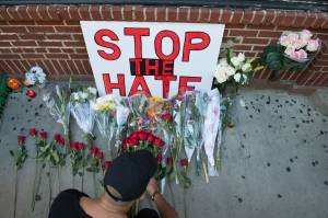 Mourners lay flowers during a vigil in New York City after the mass shooting at a gay nightclub in Orlando, Florida, on June 12, 2016. (Credit: Bryan R. Smith/AFP/Getty Images)