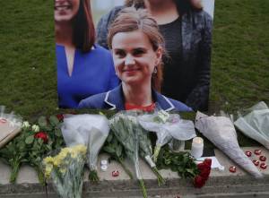 Floral tributes and candles are placed by a picture of slain Labour MP Jo Cox at a vigil in Parliament square in London on June 16, 2016. (Credit: DANIEL LEAL-OLIVAS/AFP/Getty Images)