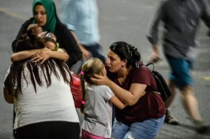 Children and their relatives embrace as they leave Ataturk airport on June 28, 2016 in Istanbul after two explosions followed by gunfire hit Turkey's biggest airport, killing at least 28 people and injuring 20. (Credit: Ozan Kose/AFP/Getty Images)