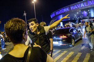 A Turkish police officer directs a passenger at Ataturk airport in Istanbul June 28, 2016 after two explosions followed by gunfire hit Turkey's biggest airport. (Credit: OZAN KOSE/AFP/Getty Images)