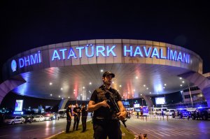 A Turkish riot police officer patrols Ataturk Airport’s main entrance in Istanbul on June 28, 2016, after two explosions followed by gunfire hit Turkey's largest airport, killing at least 41 people and injuring 239. (Credit: Ozan Kose/AFP/Getty Images)