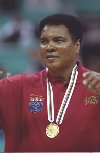 Muhammad Ali receives a replacement gold medal for one he lost many years ago during a halftime ceremony of the Yugoslavia v USA basketball game at the Georgia Dome at the 1996 Centennial Olympic Games in Atlanta, Georgia. (Credit: Getty Images)