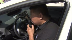 An ignition interlock device is demonstrated at a MADD media event in L.A. on June 24, 2016. (Credit: KTLA)