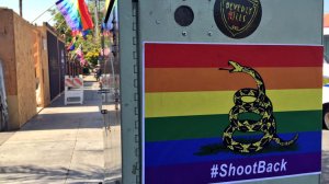 Stickers featuring a rainbow-colored version of the Gadsden flag were hanging near the Abbey Food & Bar, a well-known West Hollywood gay bar, on Thursday morning. (Credit: Hailey Branson-Potts/Los Angeles Times)