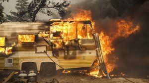 A trailer is engulfed by flames, on South Kelso Valley Road, in Weldon. (Marcus Yam / Los Angeles Times) 