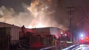 A magnesium fueled fire that burned through two commercial buildings in Maywood caused several explosions and left thousands without power Tuesday morning. (Credit: KTLA)