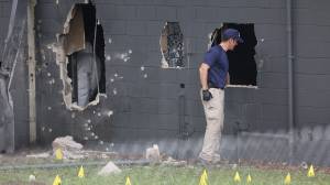 FBI agents investigate the damaged rear wall of the Pulse Nightclub where Omar Mateen allegedly killed at least 50 people on June 12, 2016 in Orlando. (Credit: Joe Raedle/Getty Images)