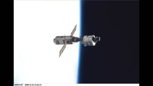 The Zarya control module, on the left with the solar panels, floats above Earth with its newly attached Unity module after the first assembly sequence in December 1998. (Credit: NASA)