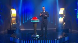 John Oliver forgave nearly $15 million of medical debt with a tap of a giant red button on Sunday night. (Credit: HBO)