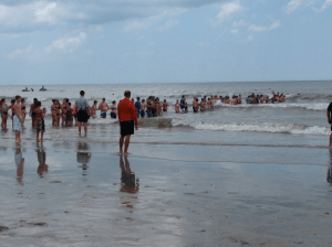 A "human chain" works to help find a missing swimmer in Myrtle Beach, South Carolina, on June 16, 2016. (Credit: Brad Jones/WGHP)