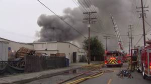 A dark plume of smoke is seen emanating from a commercial fire in Maywood on June 14, 2016. (Credit: KTLA)