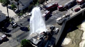 An RV sheared a fire hydrant and struck a fence on an overpass in Canoga Park on July 4, 2016. (Credit: KTLA)