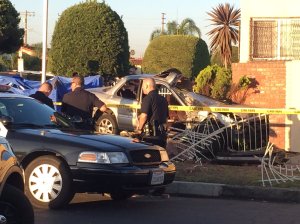 A car slammed into a home in South Los Angeles on July 17, 2016, leaving a 7-year-old girl dead and four others injured. (Credit: KTLA)