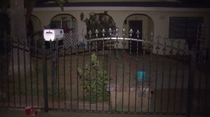 A man was found buried in the backyard of this Colton home on July 25, 2016. A small memorial was set up in front of the home. (Credit: KTLA)