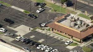 Police investigate at a Carl's Jr. where an off-duty officer shot and killed a would-be robber on July 6, 2016. (Credit: KTLA)