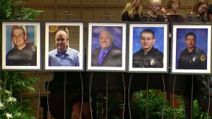 The five officer killed by a sniper in Dallas are shown in photos displayed at a memorial service for them on July 12, 2016. (Credit: CNN)