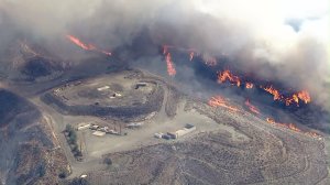 Smoke and flames rise from the Sand Fire on July 22, 2016. (Credit: KTLA)