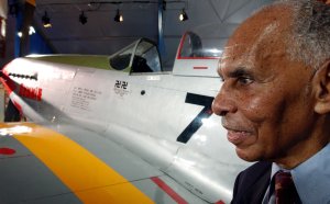 Captain Roscoe C. Brown (RET) stands next to the actual P-51 Mustang he flew as a member of the Tuskegee Airmen during World War II. (Credit: Stephen Chernin/Getty Images)