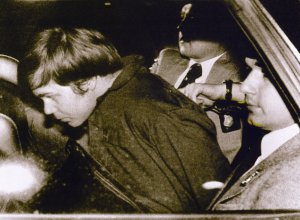 This 1981 file photo shows John Hinckley Jr. escorted by police in Washington, DC, following his arrest after shooting and seriously wounding then US president Ronald Reagan. (Credit: AFP/AFP/Getty Images)