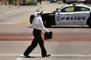 A man walks near a blocked-off area which is a crime investigation scene in downtown Dallas, texas, following the deaths of five police officers during a march on July 8, 2016 (Credit: Spencer Platt/Getty Images)