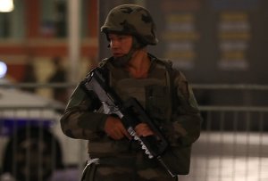 A soldier stands guard near the site of an attack in the French Riviera town of Nice, after a van that plowed into a crowd leaving a fireworks display on July 14, 2016. (Credit: VALERY HACHE/AFP/Getty Images)