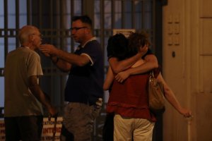 People react in the French Riviera town of Nice on July 15, 2016, after a vehicle drove into a crowd watching a fireworks display. (Credit: VALERY HACHE/AFP/Getty Images)