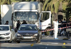 NICE, FRANCE - JULY 15:  Forensic police investigate a truck at the scene of a terror attack on the Promenade des Anglais on July 15, 2016 in Nice, France. A French-Tunisian attacker killed 84 people as he drove a truck through crowds, gathered to watch a firework display during Bastille Day celebrations. The attacker then opened fire on people in the crowd before being shot dead by police. (Photo by Patrick Aventurier/Getty Images)