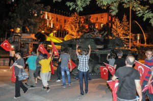 Supporters of Turkish President Erdogan react to a Turkish military tank in front of the Turkish Parliament July 15, 2016 in Istanbul, Turkey. (Credit: Kutluhan Cucel/Getty Images)