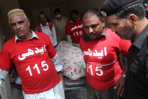 Pakistani volunteers move the body of social-media celebrity Qandeel Baloch from her residence in Lahore on July 16, 2016. (Credit: SS Mirza/AFP/Getty Images)