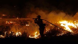 Joshua Miramontes with L.A. County Engine 82 works the fast-growing brush fire east of Santa Clarita. (Credit: Francine Orr / Los Angeles Times)