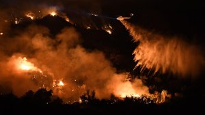 A helicopter makes a water drop on the Sand fire along Placerita Canyon Road near Santa Clarita on Sunday night. (Credit: Wally Skalij / Los Angeles Times)