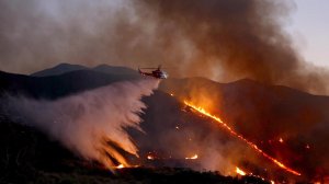 A helicopter drops water on the fast-growing Sand Fire east of Santa Clarita. (Credit: Francine Orr / Los Angeles Times)