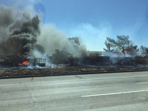 A fire at a Palmdale dog-boarding facility is shown on July 6, 2016. (Credit: Elizabeth Burnette)