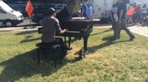 People gathered at a memorial outside the Dallas Police Department were taken by surprise on Sunday when a man pulled up on a bicycle, a piano in tow. Without saying a word, the gentleman began playing a rendition of John Lennon's "Imagine." (Credit: @liz.rd/Instagram)