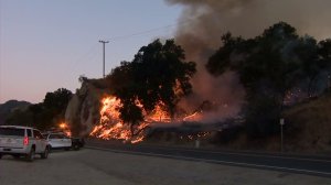 Fire burns on a hillside in Stevenson Ranch on July 10, 2016. (Credit: KTLA) 