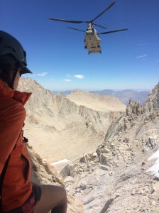 A search-and-rescue crew member is hoisted in the Mount Whitney area, where authorities are searching for a missing hiker from Mentone. (Credit: Inyo County Search and Rescue)