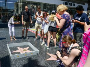 People take photos of a tiny wall around Donald Trump's star on the Hollywood Walk of Fame on July 19, 2016. (Credit: Plastic Jesus)