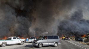 Motorists flee The Blue Cut fire as it burns out of control on both sides of Highway 138 in Summit Valley. (Credit: Gina Ferazzi / Los Angeles Times)